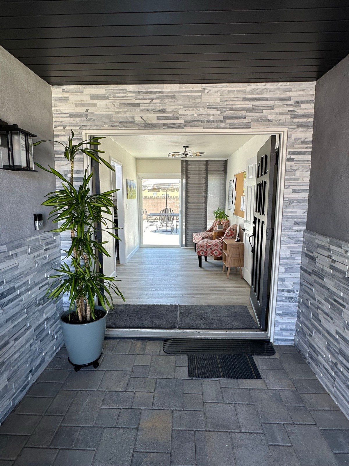 Covered front entry opening into the bright hallway