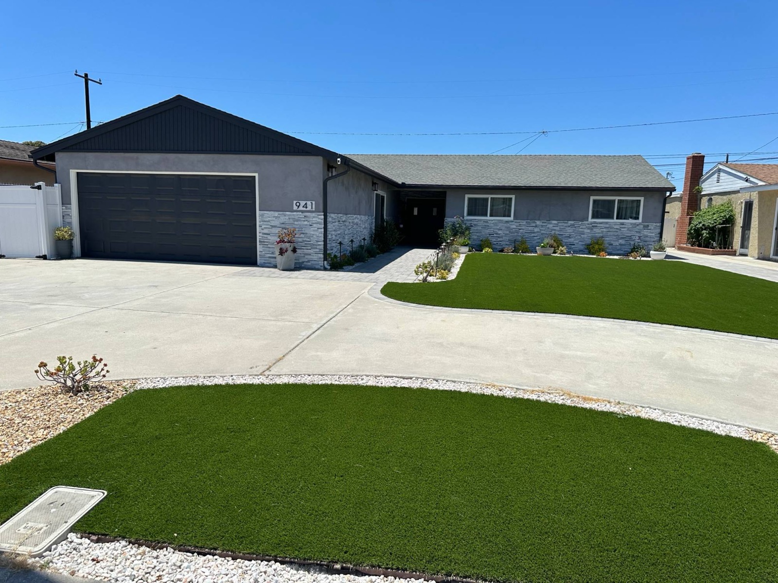 Front of Channel Islands Home at 941 Gill Ave., with a stone-trimmed facade, walkway and green lawn