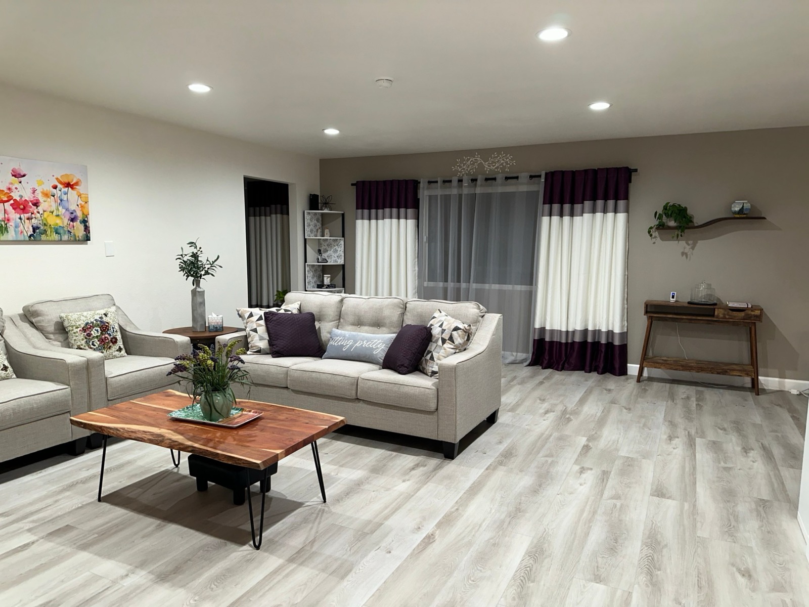 Spacious lounge with sofas and plum-accented curtains